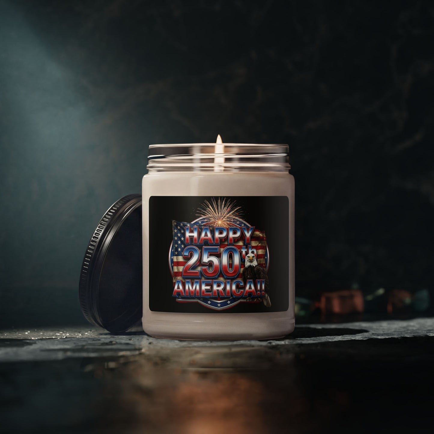 Candle in a jar with a 'Happy 250th America!!' label on a dark background.